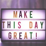 Inspirational sign displaying 'Make This Day Great' in colorful letters.