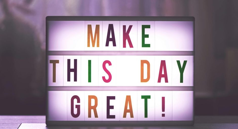 Inspirational sign displaying 'Make This Day Great' in colorful letters.