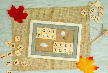 a picture frame surrounded by scrabbles and autumn leaves