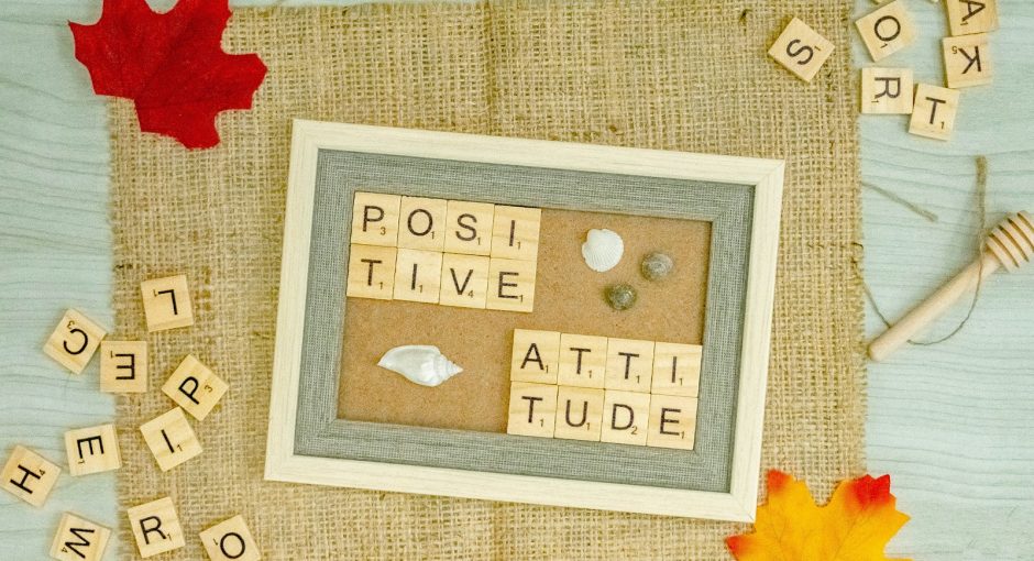 a picture frame surrounded by scrabbles and autumn leaves