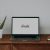 a laptop computer sitting on top of a wooden desk